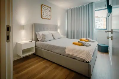 a bedroom with a bed with two towels on it at The Cale - Antero de Quental - 21 in Porto