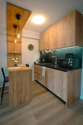 a kitchen with wooden cabinets and a counter top at The Cale - Antero de Quental 31 in Porto