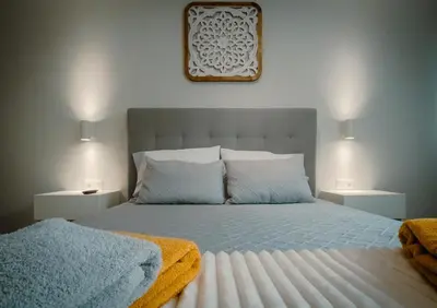 a bedroom with a large bed with two night stands at The Cale - Antero de Quental 31 in Porto