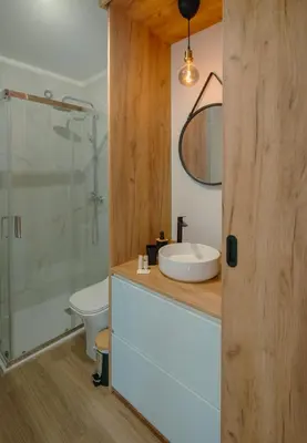 a bathroom with a sink and a glass shower at The Cale - Antero de Quental 32 in Porto