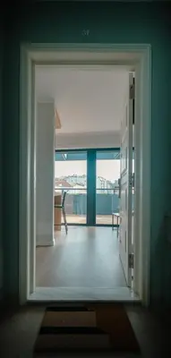an open door to a room with a view of a balcony at The Cale - Antero de Quental 32 in Porto