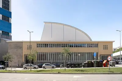 a large building with cars parked in front of it at Julio Dinis Studio in Porto