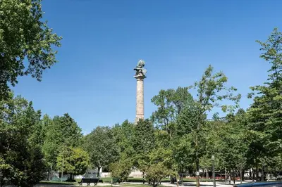 a tower in the middle of a park with trees at Julio Dinis Studio in Porto