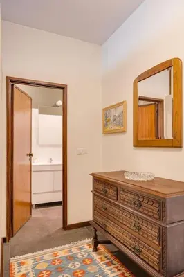 a bathroom with a dresser and a mirror on the wall at Julio Dinis Studio in Porto