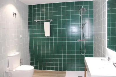 a green building with a fire hydrant in front of it at Oporto Station Hostel & Rooms in Porto