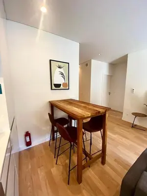 a dining room with a wooden table and chairs at Paraíso E in Porto
