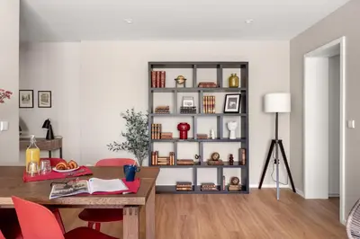 a dining room with a table and a book shelf at Wonderful 2BR Apartment in Boavista by LovelyStay in Porto
