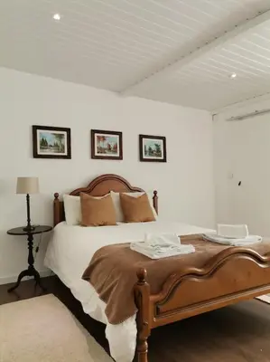 a bedroom with a large bed with two tables at Casa Cadu - Porto in Porto