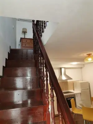 a staircase in a house with a table and a kitchen at Casa Cadu - Porto in Porto