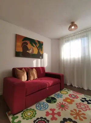 a living room with a red couch and a rug at Casa Cadu - Porto in Porto