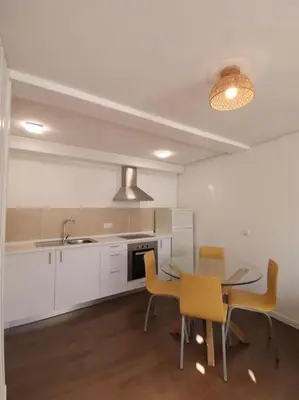a kitchen with a table and chairs and a sink at Casa Cadu - Porto in Porto