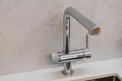 a chrome kitchen sink faucet on a counter at GuestReady - Central stay in Porto in Porto