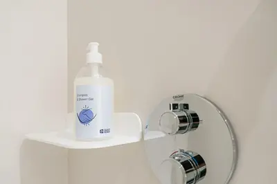 a bottle of detergent sitting on a shelf in a bathroom at GuestReady - Central stay in Porto in Porto