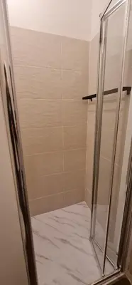 a shower with a glass door in a bathroom at Green Studio in Porto