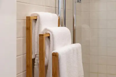 two towels on a rack in a bathroom at A Window to Porto - Premium Studio at Clérigos Tower in Porto