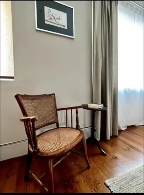 a rocking chair sitting in a room with a window at Porto Vintage House in Porto