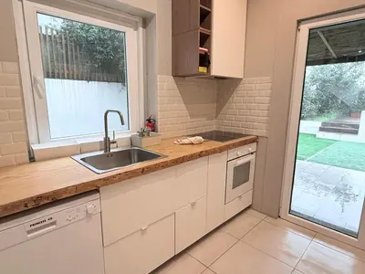 a kitchen with a sink and a window at Porto Vintage House in Porto