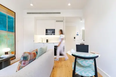a woman walking through a living room at Feel Porto Clerigos Charm Flats in Porto