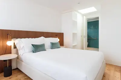 a bedroom with a large white bed with two pillows at Feel Porto Clerigos Charm Flats in Porto