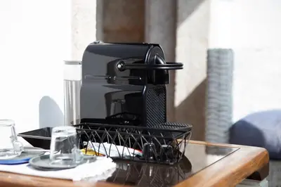 a coffee maker sitting on top of a table at Trindade Premium Suites & Apartments in Porto