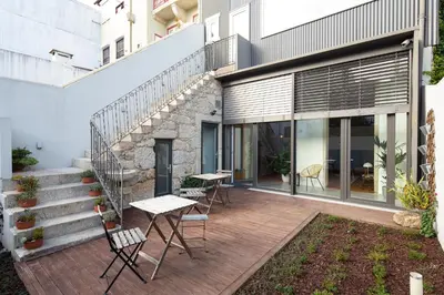 a patio with tables and chairs on a building at Trindade Premium Suites & Apartments in Porto