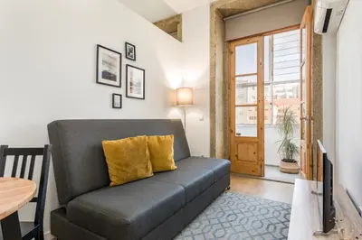a living room with a couch and a table at Apartment Bolhao Market by Sweet Porto in Porto