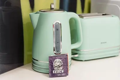 a teapot sitting on a counter next to a toaster at GuestReady - Picaria Graffiti in Porto