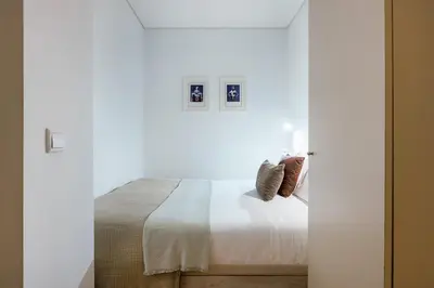 a living room with a table and a window at Porto Cozy Living in Porto