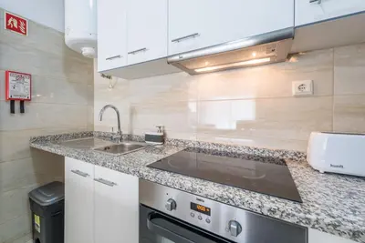 a kitchen with a sink and a counter top at GuestReady - Cedofeita Cradle in Porto