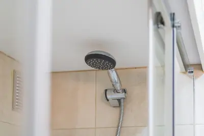 a shower with a shower head in a bathroom at GuestReady - Cedofeita Cradle in Porto