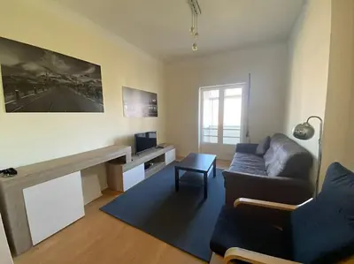 a living room with a couch and a table at Casa do Carmo in Porto