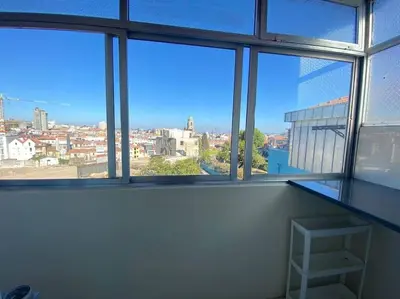 a bathroom with a toilet and a glass shower door at Casa do Carmo in Porto