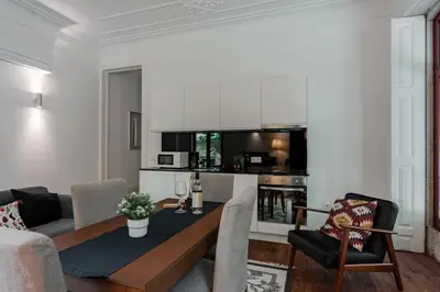 a living room with a table and a kitchen at Bonfim Apartment by Best2Stay in Porto