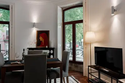 a living room with a dining table and a television at Bonfim Apartment by Best2Stay in Porto