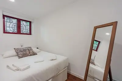 a bedroom with a bed and a mirror at Bonfim Apartment by Best2Stay in Porto