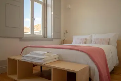 a bedroom with a bed and a table with towels at CL Ildefonso I Apartment in Porto