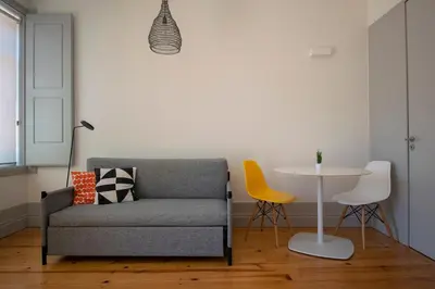 a living room with a chair and a table at CL Ildefonso I Apartment in Porto