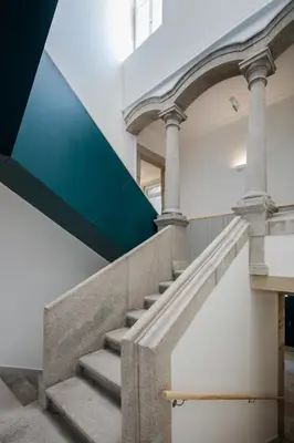 a set of stairs in a building with a blue stripe at CL Ildefonso I Apartment in Porto