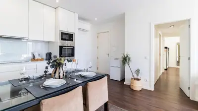 a kitchen and dining room with a table and chairs at 2BR Wonder in the City Center by LovelyStay in Porto