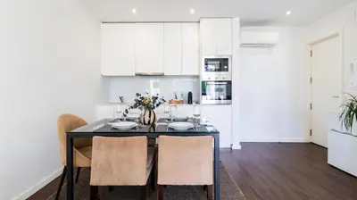 a kitchen with a dining room table with chairs at 2BR Wonder in the City Center by LovelyStay in Porto