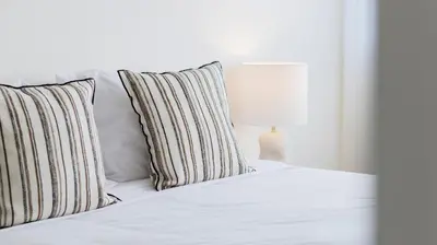 a white bed with two pillows and a lamp at 2BR Wonder in the City Center by LovelyStay in Porto