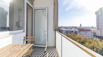 a balcony with a bench and a view of the city at 2BR Wonder in the City Center by LovelyStay in Porto