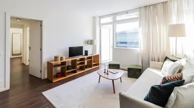 a living room with a couch and a tv at 2BR Wonder in the City Center by LovelyStay in Porto