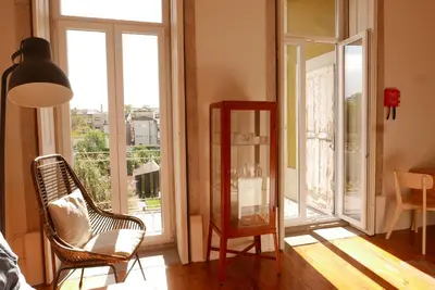 a living room with a chair and a mirror at Breiner Apartment, Arts District in Porto