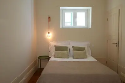 a bedroom with a bed with two pillows and a window at Breiner Apartment, Arts District in Porto