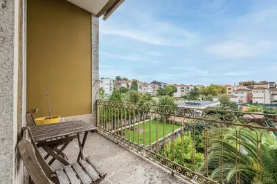 a balcony with a bench and a view of a park at Breiner Apartment, Arts District in Porto
