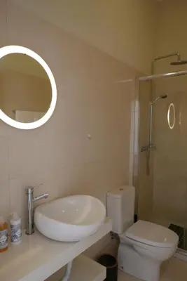 a bathroom with a sink and a toilet and a mirror at Breiner Apartment, Arts District in Porto