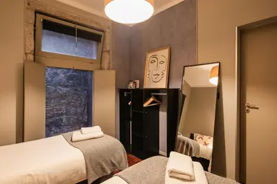 a bedroom with a bed and a mirror and a window at Porto Insight Apartments- with balcony in Porto