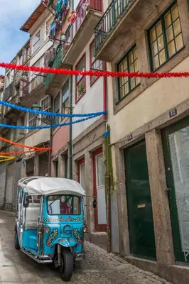 a blue car parked on a street next to a building at Porto Insight Apartments- with balcony in Porto