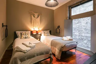 a bedroom with two beds and a window at Porto Insight Apartments- with balcony in Porto